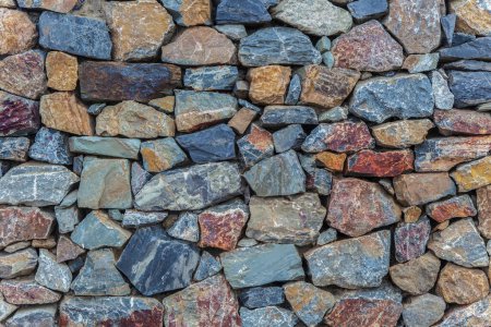 Photo for Natural colorful rust quarzite wall. Irregular shape stones - Royalty Free Image