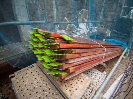 Photo for Wooden scaffolds elements piled at old town construction site. Spray paint marked on them - Royalty Free Image