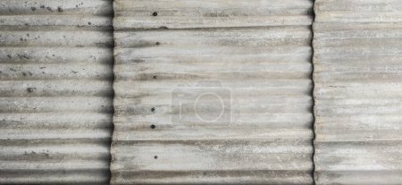 Foto de Wall protected with fibre cement corrugated sheets. Disused construction material for containing elements harmful to human health - Imagen libre de derechos
