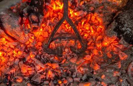 Foto de Heating branding iron for cattle over embers. Selective focus - Imagen libre de derechos