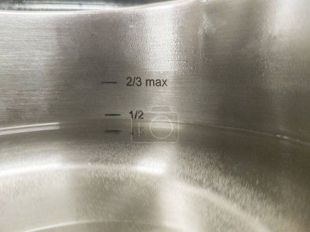 Téléchargez les photos : Stainless Steel Pressure Cooker at work. Liquid level markings - en image libre de droit