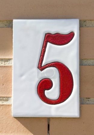 Photo for House number 5 over brick sunny wall. Houses with personality concept - Royalty Free Image