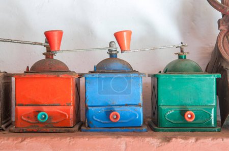 Old manual colorful coffee grinders. Country style background