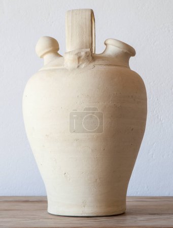 Photo for White earthenware botijo, traditional clay pot jug to keep fresh water. Selective focus - Royalty Free Image