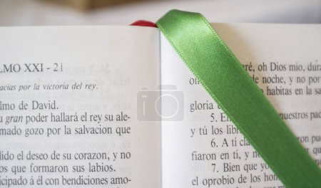Photo for Open Bible at The Book of Psalms. Green bound bookmark over the page - Royalty Free Image