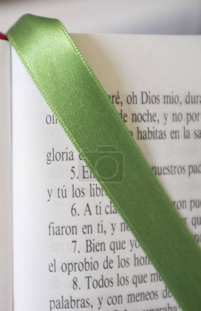 Photo for Open Bible at The Book of Psalms. Green bound bookmark over the page - Royalty Free Image