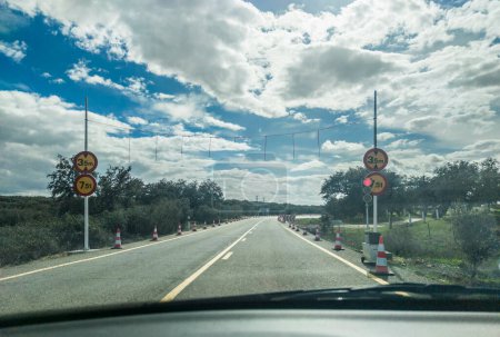 Photo for Roadworks on N523 national road. Temporary traffic lights. View from the inside of the car - Royalty Free Image
