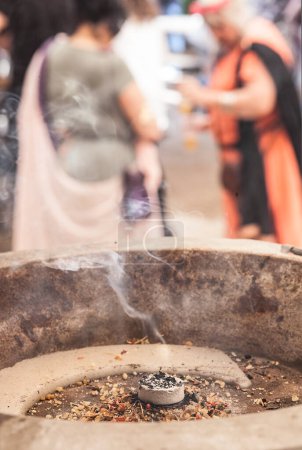 Photo for Burning incense in a cauldron. Roman reenactor women background - Royalty Free Image