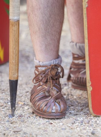 Photo for Roman legionary foot-soldier caligae beside scutum. Ground view - Royalty Free Image