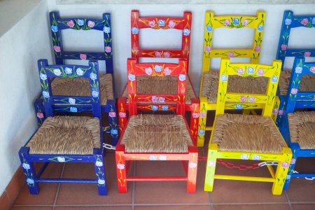 Photo for Vila Nova, Portugal - Jul 26th, 2023: Colorful children chairs. Seat made of rush leaves. Alentejo crafts - Royalty Free Image