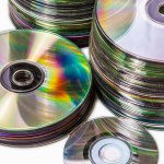 Heap of old used cd and mini disks. Isolated over white background 