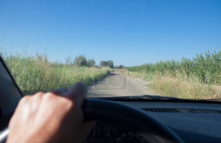Photo for Driving on a narrow local road in Vegas Altas del Guadiana. View from the inside of the car - Royalty Free Image