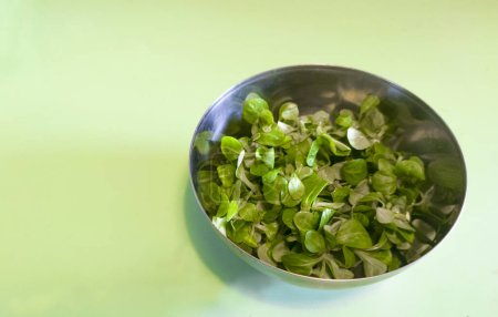 Photo for Metallic bowl full of corn salad. Turquoise background - Royalty Free Image