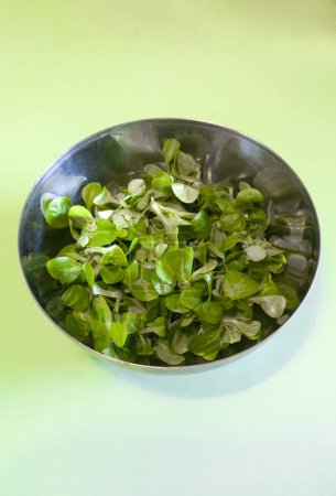 Photo for Metallic bowl full of corn salad. Turquoise background - Royalty Free Image