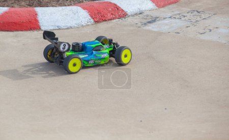 Photo for Merida, Spain - Jan 28th, 2024: Extremadura 1/8tt gas Championship RC Car. Cars making a curve over concrete surface - Royalty Free Image