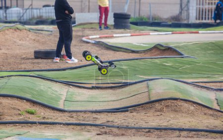 Photo for Merida, Spain - Jan 28th, 2024: Extremadura 1/8tt gas Championship RC Car. Cars jumping in an area of undulations - Royalty Free Image