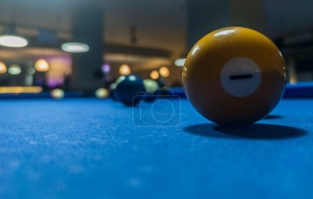 Yellow solid ball. Eight-ball pool game at six pocket blue table. 