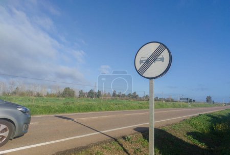 Photo for End of prohibition on overtaking metal pole. Car crossing view - Royalty Free Image
