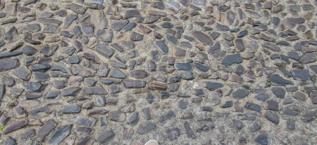 Photo for Cobblestone pavement made with quartzite undevastated stones. Monumental Complex road surfaces, Caceres, Spain - Royalty Free Image