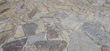 Photo for Cobblestone pavement made with quartzite undevastated slabs. Monumental Complex road surfaces, Caceres, Spain - Royalty Free Image