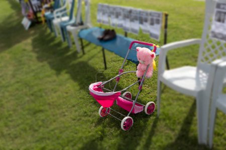 A baby stroller and a toy against a background symbolizing hostages kidnapped by terrorists and taken to the Gaza Strip