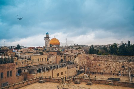 Photo for Jerusalem, Capital of Israel. Beautiful panoramic view of the Old City at sunset, Tomb of the Prophets and Dome of the Rock, typical stoned houses. Blue Sunny and Cloudy Sky.Historic Architecture. - Royalty Free Image