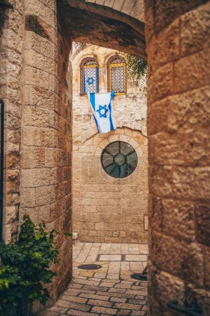 Photo for Cozy narrow small Street in the Old City of Jerusalem, Israel. Typical stoned houses and walls of jewish historic quarter area part. - Royalty Free Image