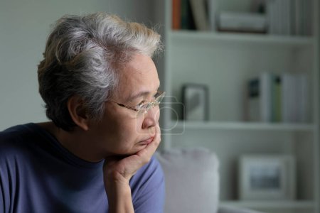 Foto de Retrato de mujer mayor asiática triste y solitaria en sala de estar - Imagen libre de derechos