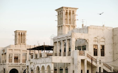 Photo for Beautiful sandstone building and flying seagulls at Al seef in Dubai heritage district. - Royalty Free Image