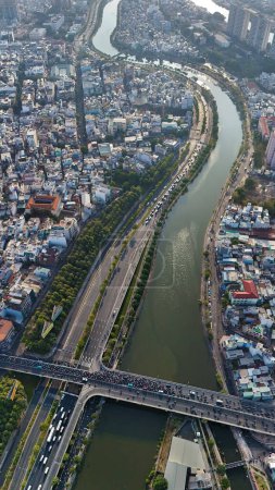 Ho chi Minh city aerial view with canal system, overcrowded riverside urban, Vo Van Kiet avenue along Tau Hu canal, dense density and crowded townhouse of big Asian town, Saigon, Viet Na