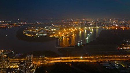 Aerial view from drone of Ho Chi Minh city port, canal system for traffic waterway on Saigon river, crane and container at riverside harbor, logistic for export, import industrial with cheap expense