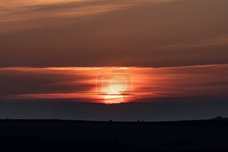 Téléchargez les photos : Soleil se cachant derrière les nuages au coucher du soleil - en image libre de droit