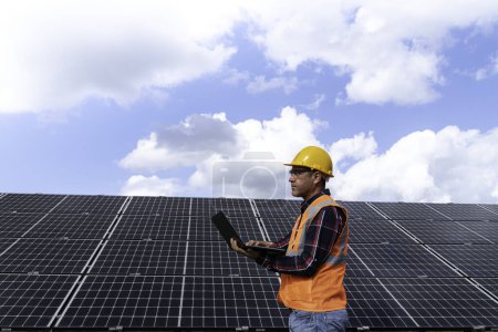Photo for Portrait of male manager engineer in safety helmet checking with computer an operation of solar panel system at solar station - Royalty Free Image