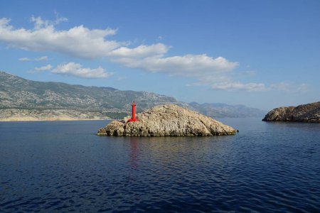 Photo for Red lighthouse on the small stony island in the Croatian sea during summer - Royalty Free Image
