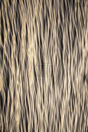 Vertically oriented abstract background with wavy enlightened texture