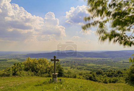 Landscape with a worship cross in a village on the mountain
