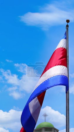 Costa Rica Flag proudly waving in San Jose. Large Costa Rica flag is flying high in city center.
