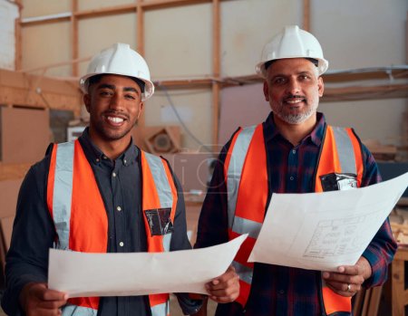 Photo pour Portrait de groupe d'hommes multiraciaux souriant dans un casque de sécurité et des vêtements réfléchissants à l'usine de travail du bois - image libre de droit