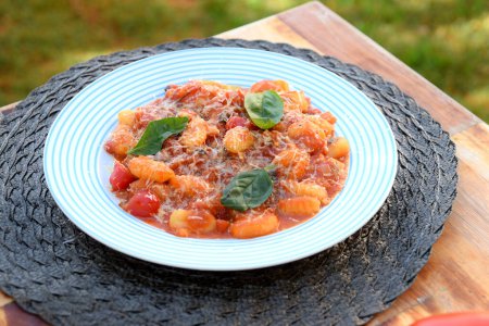 Gnocchi with red Bolognese sauce, typical Italian pasta potato food taste
