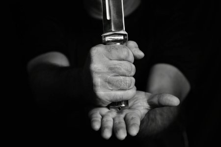 man wielding make expressively holding cutting metal blade black and white photo art expression image