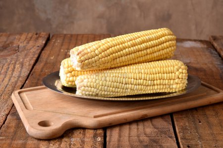 Foto de Maíz comida natural saludable delicioso vegano cocido maíz verde en madera mesa sabor - Imagen libre de derechos