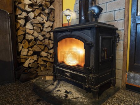 Wood stove with a woodshed in background