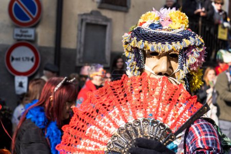 Foto de Shignano (Italy) 21/02/2023: The carnival of Schignano parade is one of the most famous traditional carnivals of north Italy with typical wood masks and performer that entertain the visitors . - Imagen libre de derechos