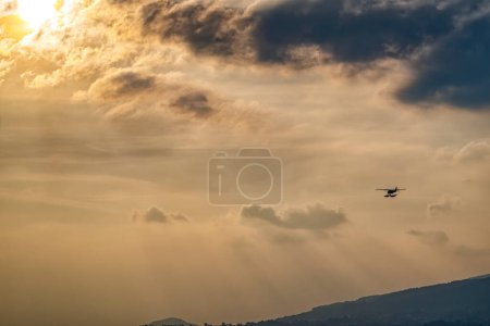 Photo for Seaplane flying at sunset hours - Royalty Free Image