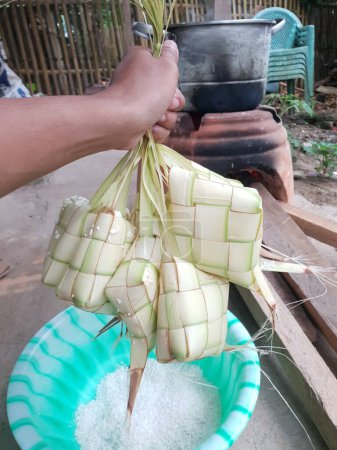 Photo for Ketupat filled with rice ready to be cooked - Royalty Free Image