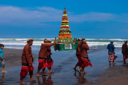 Photo for Parang Tritis Beach, Yogyakarta 7 June 2022: Annual Festival of the Sea Offering. The community around Parangtris beach holds a traditional celebration called Labuhan Bhakti Pisungsung Jaladri. - Royalty Free Image