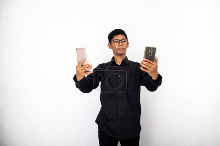 Photo for Asian businessman with mobile phones in his hands isolated on white background. - Royalty Free Image