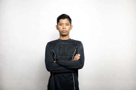 Emotional asian man in black clothes posing on white studio background 