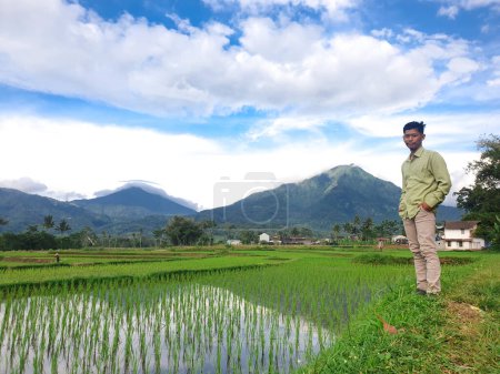 Foto de Asiático hombre con de pie en verde prado, nublado cielo fondo - Imagen libre de derechos