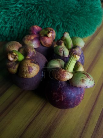 Photo for Mangosteen fruits on wooden table, closeup view - Royalty Free Image